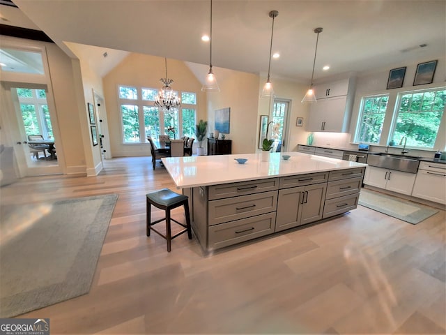 1330 Jackson Ridge Rd, Greensboro, GA 30642 - kitchen featuring healthy amount of natural light, light wood-style flooring, a breakfast bar, a chandelier, and recessed lighting