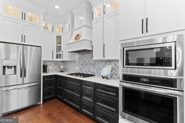 1413 N Walkers Mill Rd, Griffin, GA 30223 - kitchen featuring stainless steel appliances, dark cabinets, custom exhaust hood, white cabinetry, and light countertops