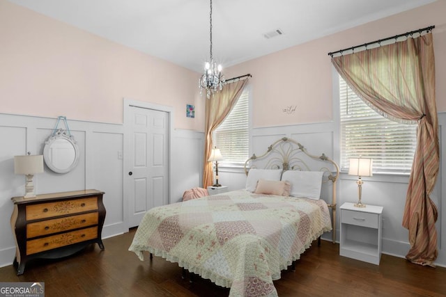 1413 N Walkers Mill Rd, Griffin, GA 30223 - bedroom with a decorative wall, a wainscoted wall, a chandelier, wood finished floors, and multiple windows