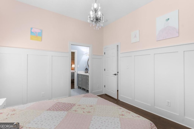 1413 N Walkers Mill Rd, Griffin, GA 30223 - bedroom with a decorative wall, dark wood-type flooring, a chandelier, wainscoting, and connected bathroom