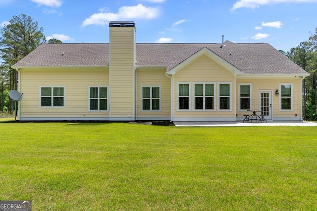 1413 N Walkers Mill Rd, Griffin, GA 30223 - back of property with a patio, a chimney, a yard, and roof with shingles