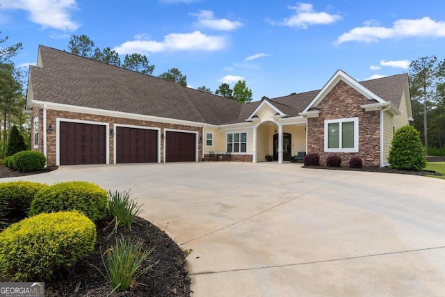 1413 N Walkers Mill Rd, Griffin, GA 30223 - view of front facade featuring stone siding, driveway, an attached garage, and roof with shingles