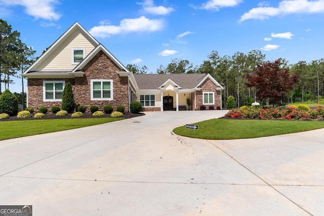 1413 N Walkers Mill Rd, Griffin, GA 30223 - view of front of home featuring stone siding, curved driveway, and a front lawn