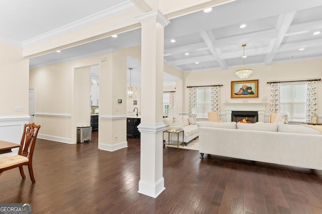 1413 N Walkers Mill Rd, Griffin, GA 30223 - living area with decorative columns, recessed lighting, dark wood-style floors, beam ceiling, and a warm lit fireplace