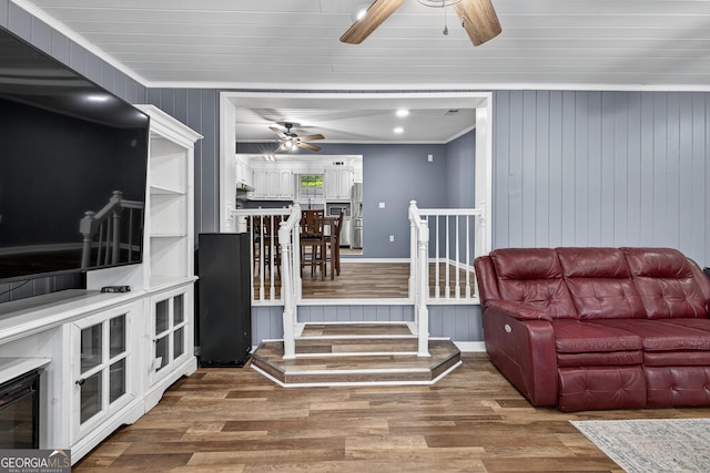 106 Oak Ln, Eatonton, GA 31024 - living area with a ceiling fan, wood finished floors, crown molding, and wood walls