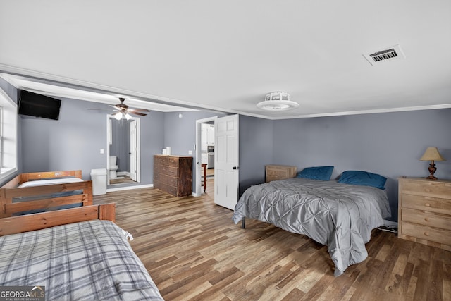 106 Oak Ln, Eatonton, GA 31024 - bedroom with wood finished floors, ornamental molding, and a ceiling fan