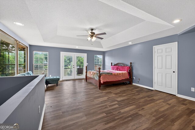 106 Oak Ln, Eatonton, GA 31024 - bedroom with a raised ceiling, dark wood-style floors, multiple windows, access to exterior, and a textured ceiling