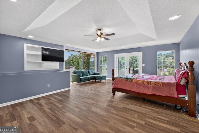 106 Oak Ln, Eatonton, GA 31024 - bedroom with a textured ceiling, french doors, wood finished floors, a tray ceiling, and access to outside