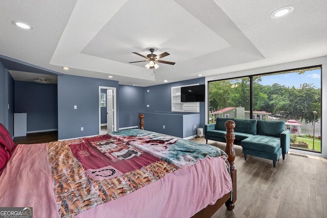 106 Oak Ln, Eatonton, GA 31024 - bedroom with a raised ceiling, wood finished floors, and recessed lighting