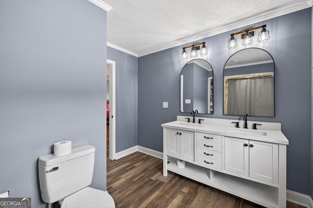 106 Oak Ln, Eatonton, GA 31024 - full bath with a textured ceiling, double vanity, ornamental molding, and wood finished floors