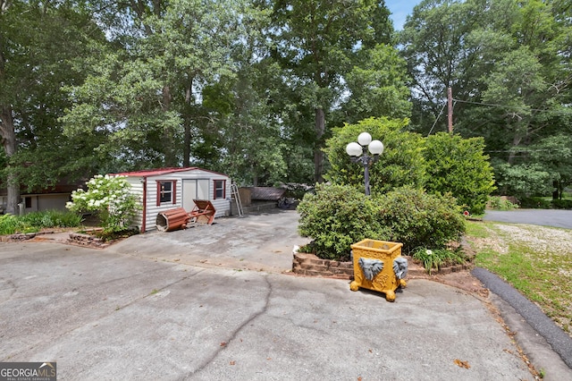 106 Oak Ln, Eatonton, GA 31024 - view of patio / terrace with view of wooded area and a storage shed