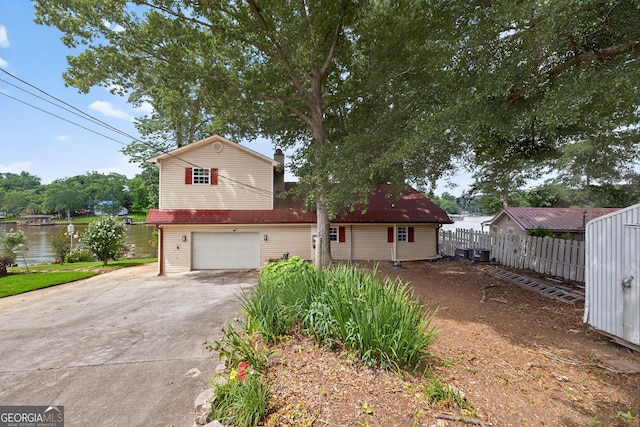 106 Oak Ln, Eatonton, GA 31024 - traditional-style house with concrete driveway, a garage, and a water view