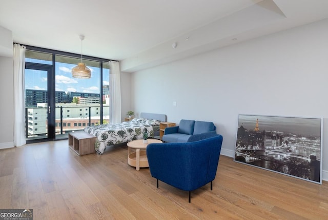 788 W Marietta St NW Unit 212, Atlanta, GA 30318 - living area with expansive windows, wood finished floors, and a city view