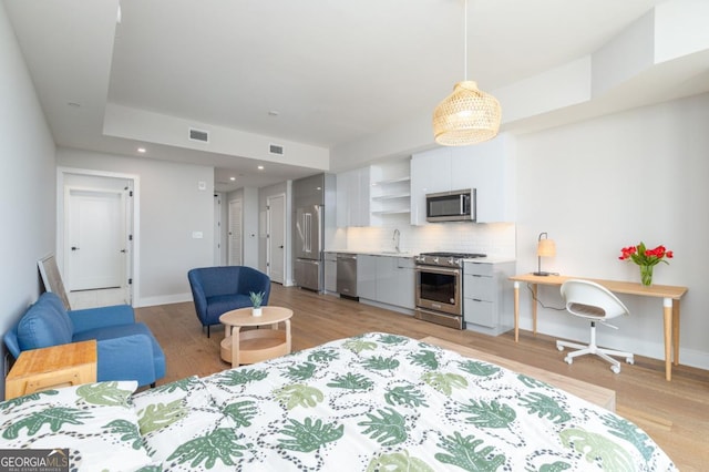 788 W Marietta St NW Unit 212, Atlanta, GA 30318 - bedroom featuring high quality fridge, light wood-style floors, and recessed lighting