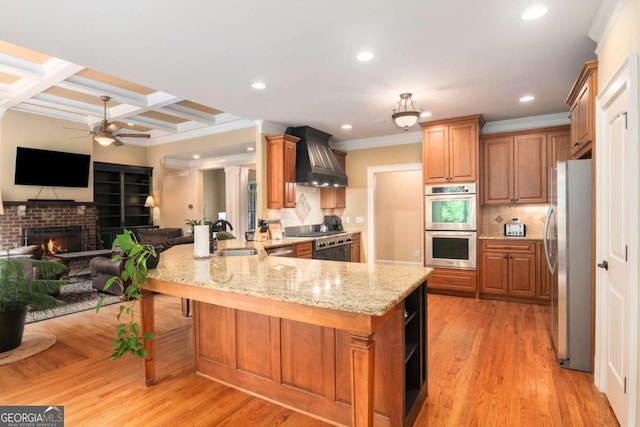 287 Scenic Falls Blvd, Hoschton, GA 30548 - kitchen featuring stainless steel appliances, premium range hood, a peninsula, open floor plan, and light stone counters
