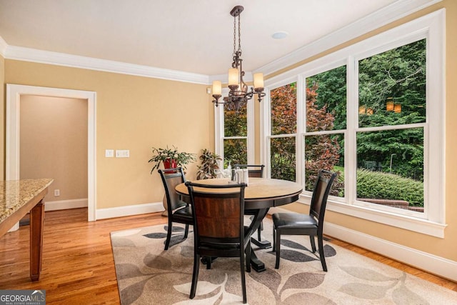 287 Scenic Falls Blvd, Hoschton, GA 30548 - dining room with a chandelier, crown molding, and light wood-style flooring