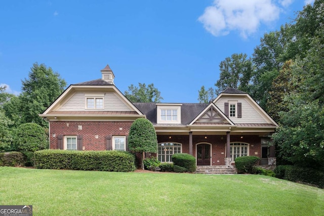 287 Scenic Falls Blvd, Hoschton, GA 30548 - view of front of house featuring brick siding, a front lawn, and a porch