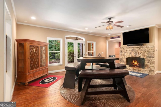 287 Scenic Falls Blvd, Hoschton, GA 30548 - living area featuring wood-type flooring, french doors, a ceiling fan, a stone fireplace, and recessed lighting