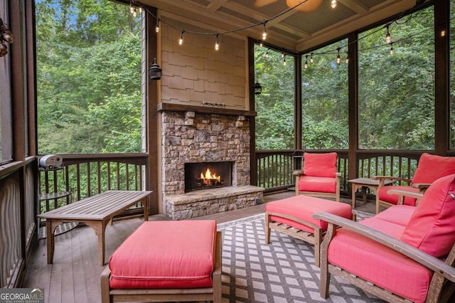 287 Scenic Falls Blvd, Hoschton, GA 30548 - sunroom featuring a stone fireplace, track lighting, and healthy amount of natural light