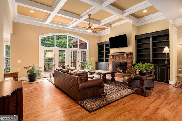 287 Scenic Falls Blvd, Hoschton, GA 30548 - living area featuring ceiling fan, coffered ceiling, a fireplace, wood finished floors, and beam ceiling