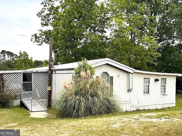 1004 Gordon Ave, Mcrae-Helena, GA 31037 - view of home's exterior with a lawn and view of scattered trees