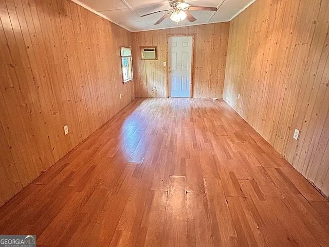 1004 Gordon Ave, Mcrae-Helena, GA 31037 - empty room with light wood-style flooring, ceiling fan, wood walls, and a wall unit AC