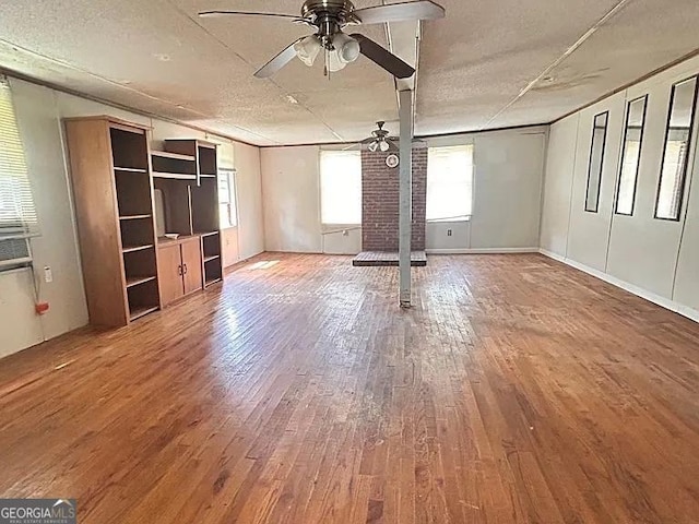 1004 Gordon Ave, Mcrae-Helena, GA 31037 - unfurnished living room featuring ceiling fan, wood finished floors, and a textured ceiling