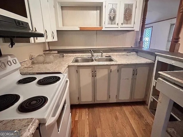 1004 Gordon Ave, Mcrae-Helena, GA 31037 - kitchen with electric stove, light wood-style flooring, light countertops, extractor fan, and open shelves