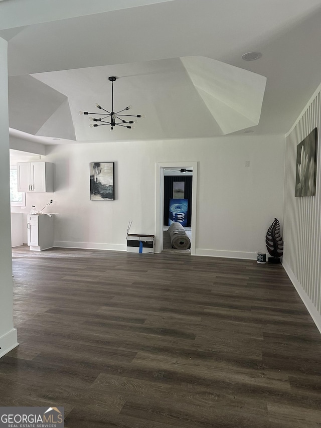 503 S Dooly St, Montezuma, GA 31063 - unfurnished living room with a chandelier, dark wood-style flooring, and vaulted ceiling