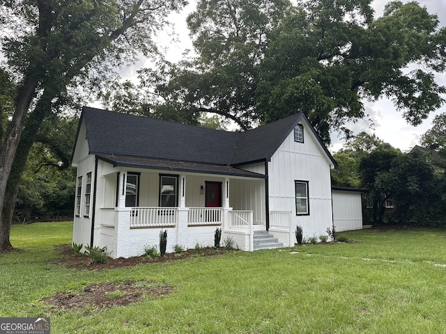 503 S Dooly St, Montezuma, GA 31063 - view of front of property with a porch, roof with shingles, a front lawn, and board and batten siding