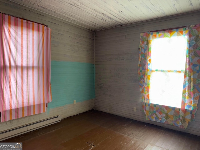 104 W Mauldin St, Walhalla, SC 29691 - empty room featuring a baseboard heating unit and wood-type flooring