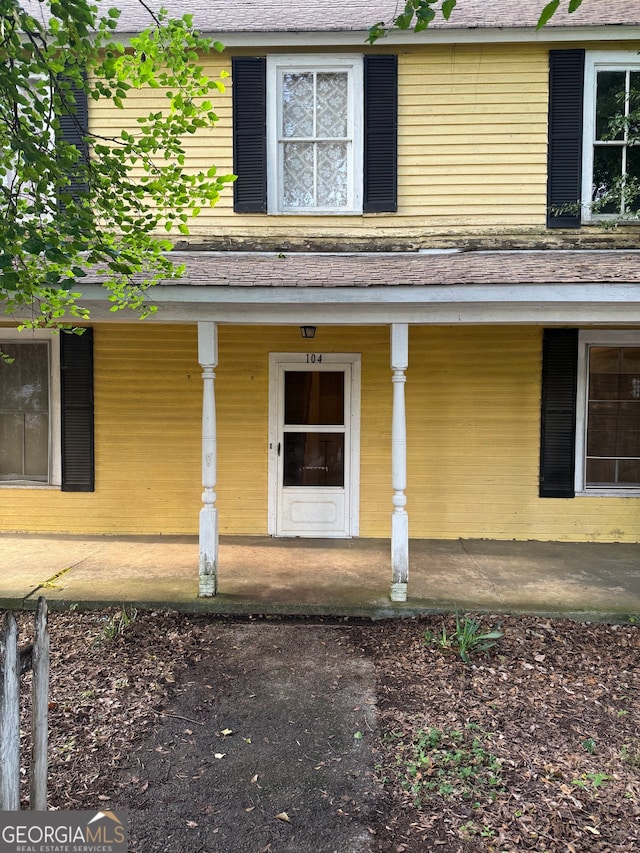 104 W Mauldin St, Walhalla, SC 29691 - view of exterior entry featuring a porch and roof with shingles
