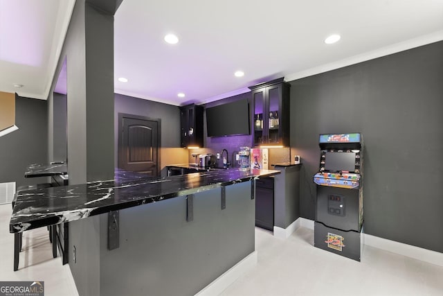 4130 Millbrook Ct, Suwanee, GA 30024 - kitchen featuring recessed lighting, a breakfast bar, tasteful backsplash, and dark stone countertops
