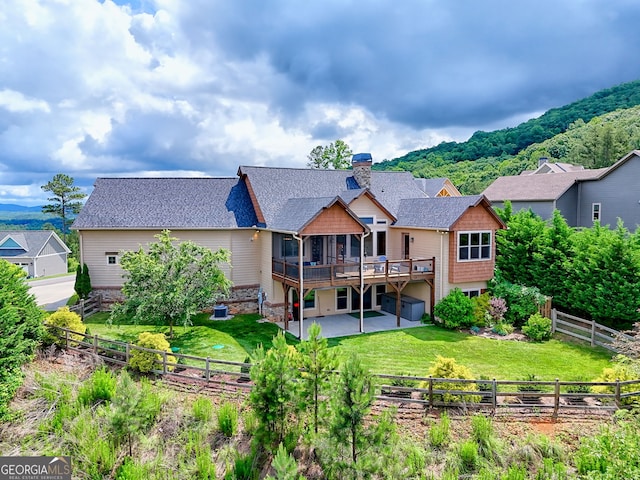 899 Ridge Pointe Way, Blairsville, GA 30512 - back of house featuring a wooden deck, a patio area, a chimney, a fenced backyard, and roof with shingles