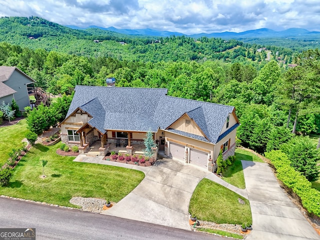 899 Ridge Pointe Way, Blairsville, GA 30512 - view of front of home featuring stone siding, a porch, a view of trees, concrete driveway, and a garage