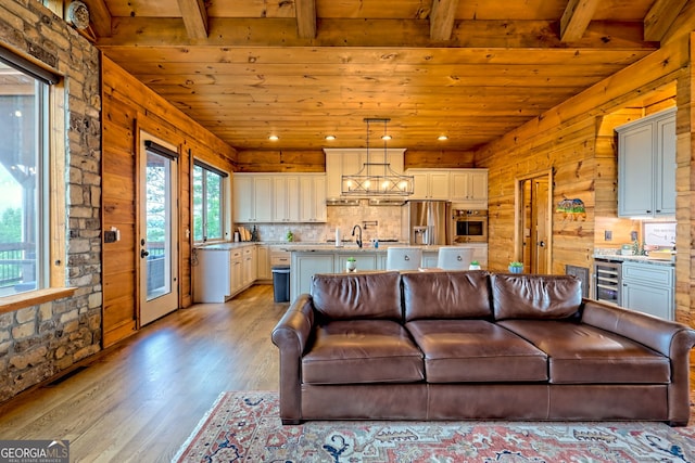 899 Ridge Pointe Way, Blairsville, GA 30512 - living area with a wood ceiling with exposed beams, plenty of natural light, light wood finished floors, beverage cooler, and wood walls
