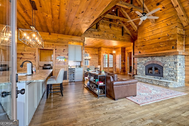 899 Ridge Pointe Way, Blairsville, GA 30512 - living area featuring beverage cooler, wooden walls, a wood ceiling with exposed beams, a chandelier, and wood finished floors