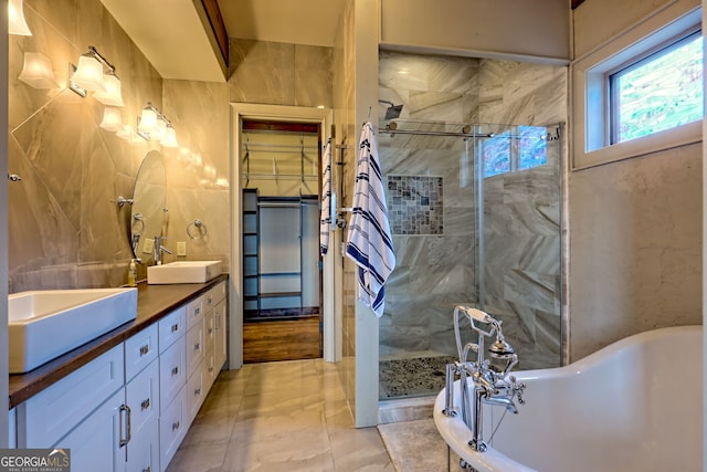 899 Ridge Pointe Way, Blairsville, GA 30512 - full bathroom with double vanity, a stall shower, a freestanding tub, and tile walls