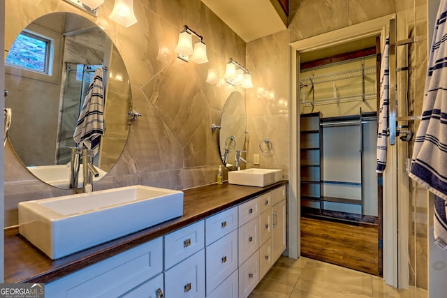 899 Ridge Pointe Way, Blairsville, GA 30512 - full bath featuring double vanity, a walk in closet, tile patterned floors, and tile walls