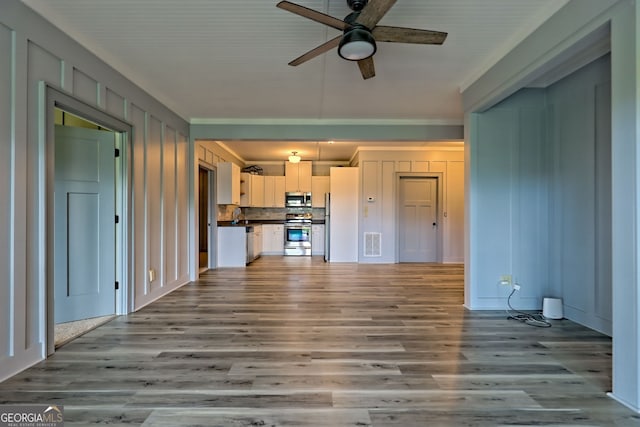 899 Ridge Pointe Way, Blairsville, GA 30512 - unfurnished living room featuring ceiling fan, wood finished floors, and crown molding