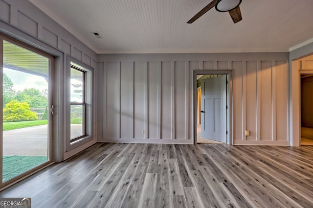 899 Ridge Pointe Way, Blairsville, GA 30512 - empty room with a ceiling fan, light wood finished floors, and a decorative wall