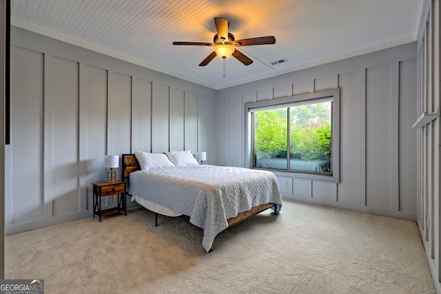 899 Ridge Pointe Way, Blairsville, GA 30512 - bedroom with a decorative wall, light carpet, ornamental molding, and ceiling fan