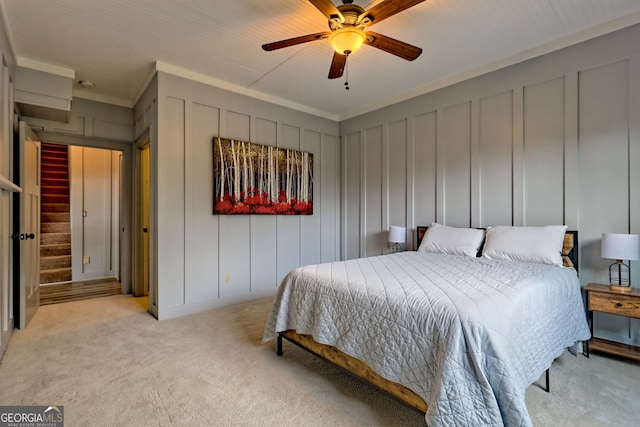899 Ridge Pointe Way, Blairsville, GA 30512 - bedroom featuring light carpet, a decorative wall, ornamental molding, and a ceiling fan