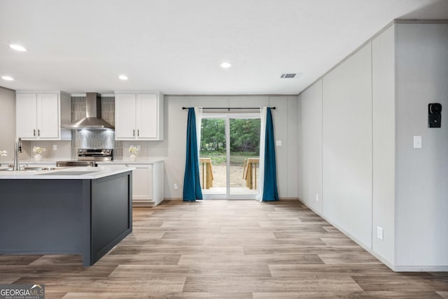 1413 Hephzibah Mcbean Rd, Hephzibah, GA 30815 - kitchen featuring wall chimney range hood, stainless steel electric range oven, light countertops, white cabinetry, and recessed lighting