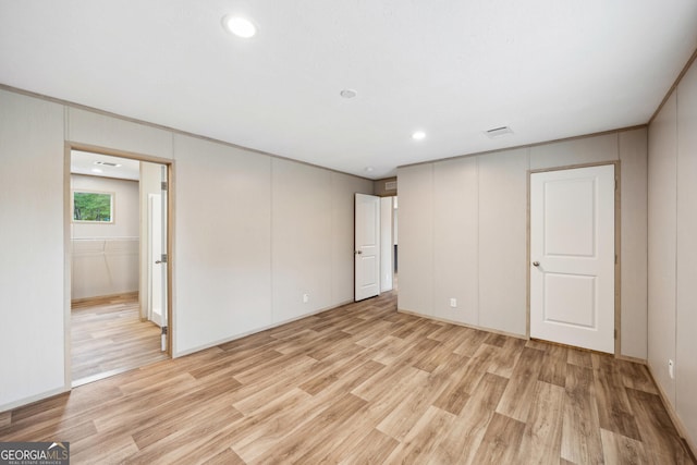1413 Hephzibah Mcbean Rd, Hephzibah, GA 30815 - unfurnished bedroom with light wood-style flooring, a decorative wall, and recessed lighting