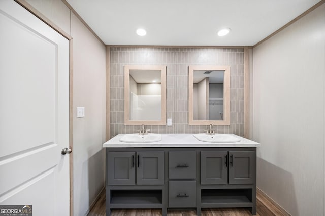 1413 Hephzibah Mcbean Rd, Hephzibah, GA 30815 - full bath with double vanity, decorative backsplash, wood finished floors, tile walls, and recessed lighting