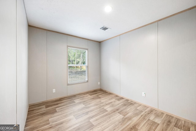 1413 Hephzibah Mcbean Rd, Hephzibah, GA 30815 - spare room featuring wood finished floors, a decorative wall, and ornamental molding