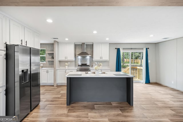 1413 Hephzibah Mcbean Rd, Hephzibah, GA 30815 - kitchen with stainless steel appliances, wall chimney range hood, recessed lighting, light countertops, and white cabinetry