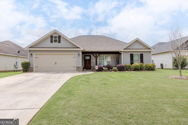 311 Kendall Ct, Perry, GA 31069 - view of front of property featuring driveway, an attached garage, a front lawn, and board and batten siding