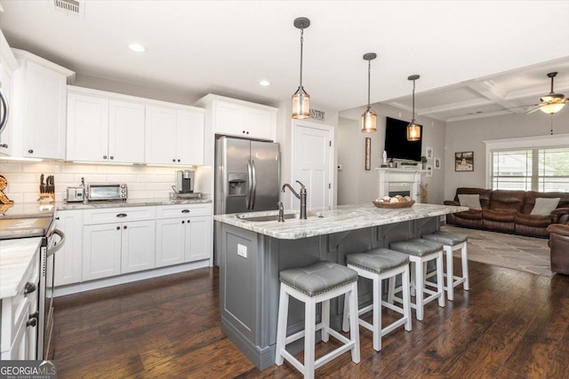 311 Kendall Ct, Perry, GA 31069 - kitchen with appliances with stainless steel finishes, open floor plan, coffered ceiling, backsplash, and dark wood-type flooring